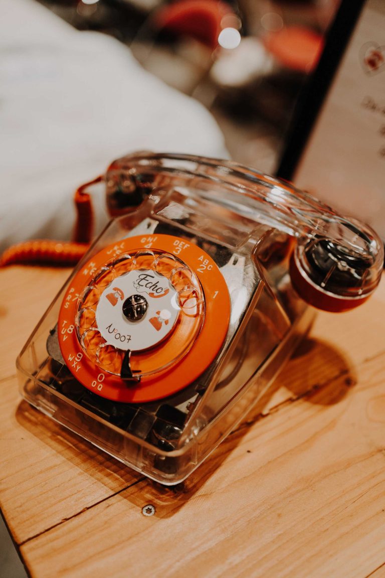 Téléphone vintage transparent Echo sur une table en bois.